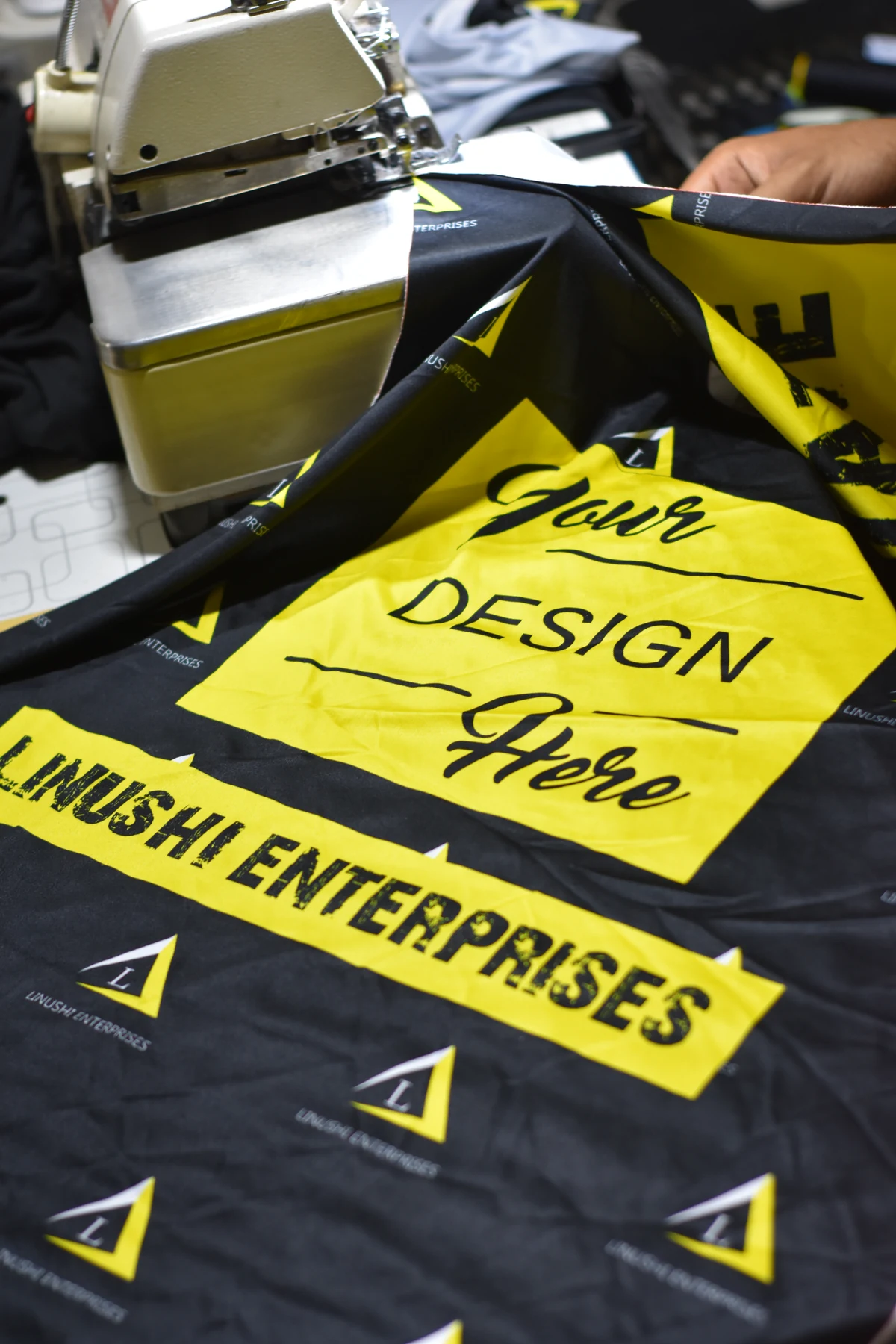 Cut and sew manufacturer producing a custom apparel garment from raw fabric panels on the factory floor