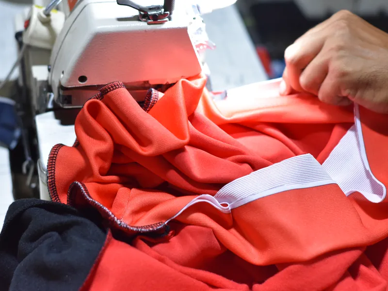 Garment being stitched on the cut-and-sew production line
