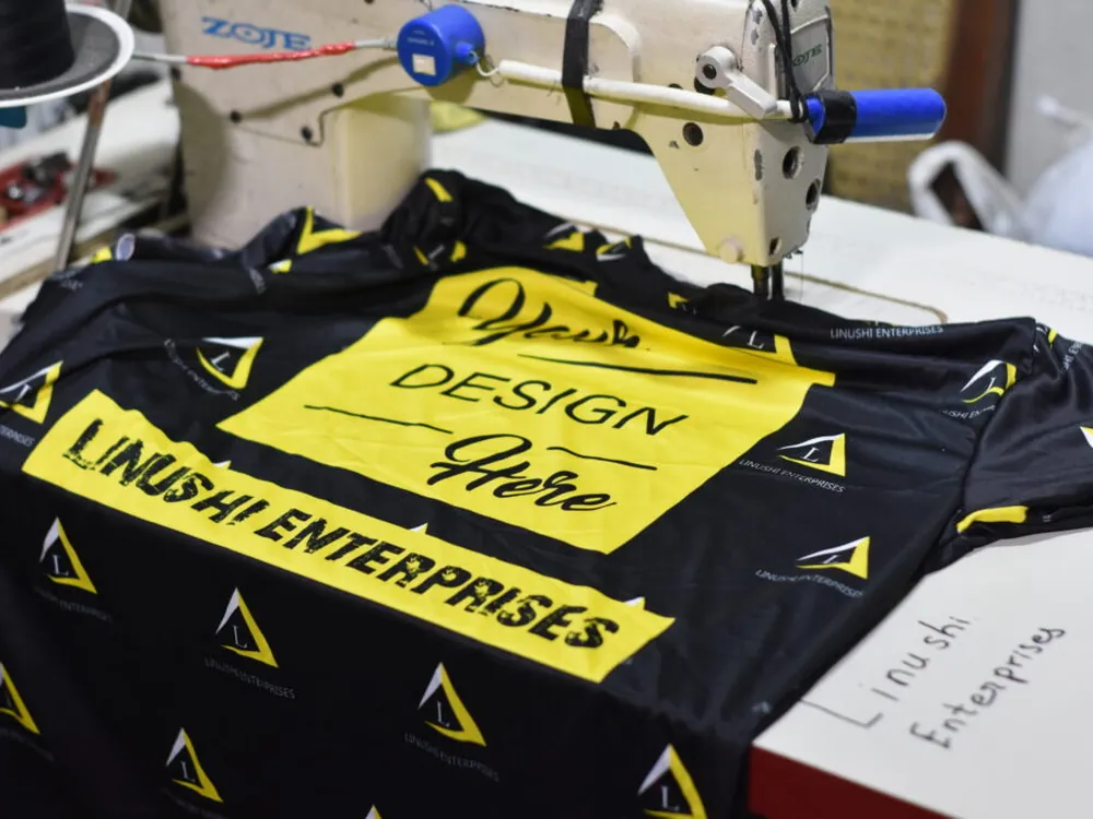 OEM clothing manufacturer stitching a custom-printed t-shirt to a brand's own design