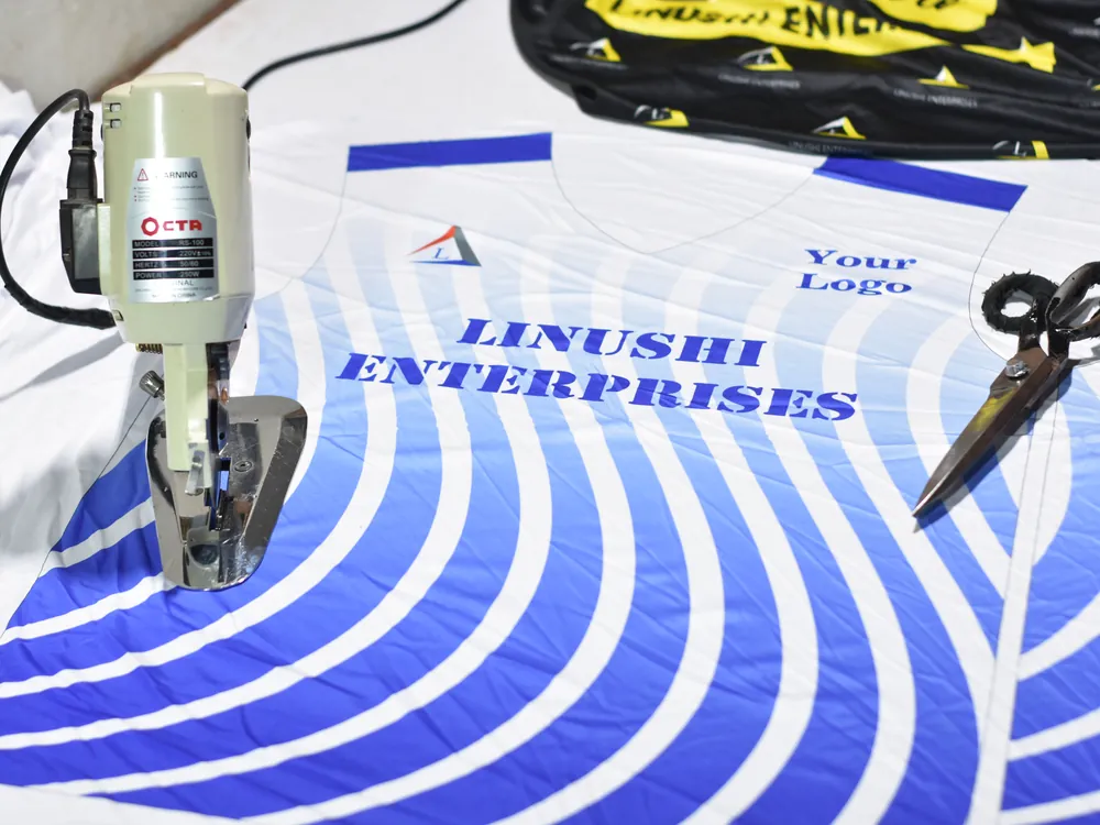 Sublimated fabric panels being cut to pattern with a brand logo placement at Linushi