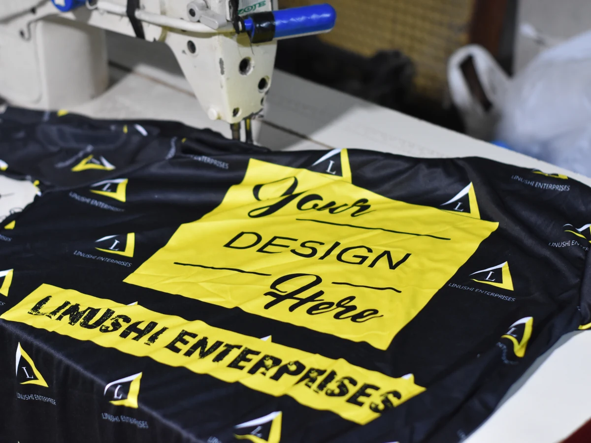 Custom t shirt manufacturer — all-over sublimation printed sample tee under the sewing machine on Linushi's production line