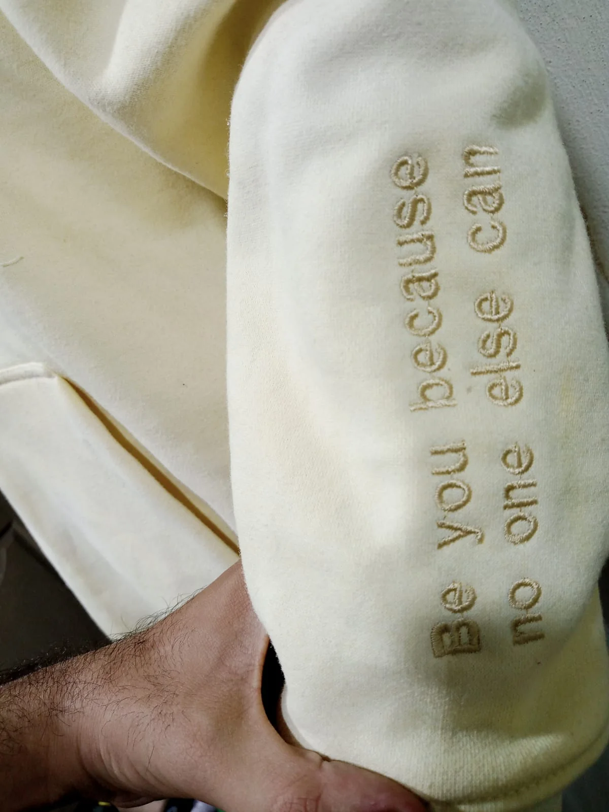 Sleeve embroidery on the cream hoodie