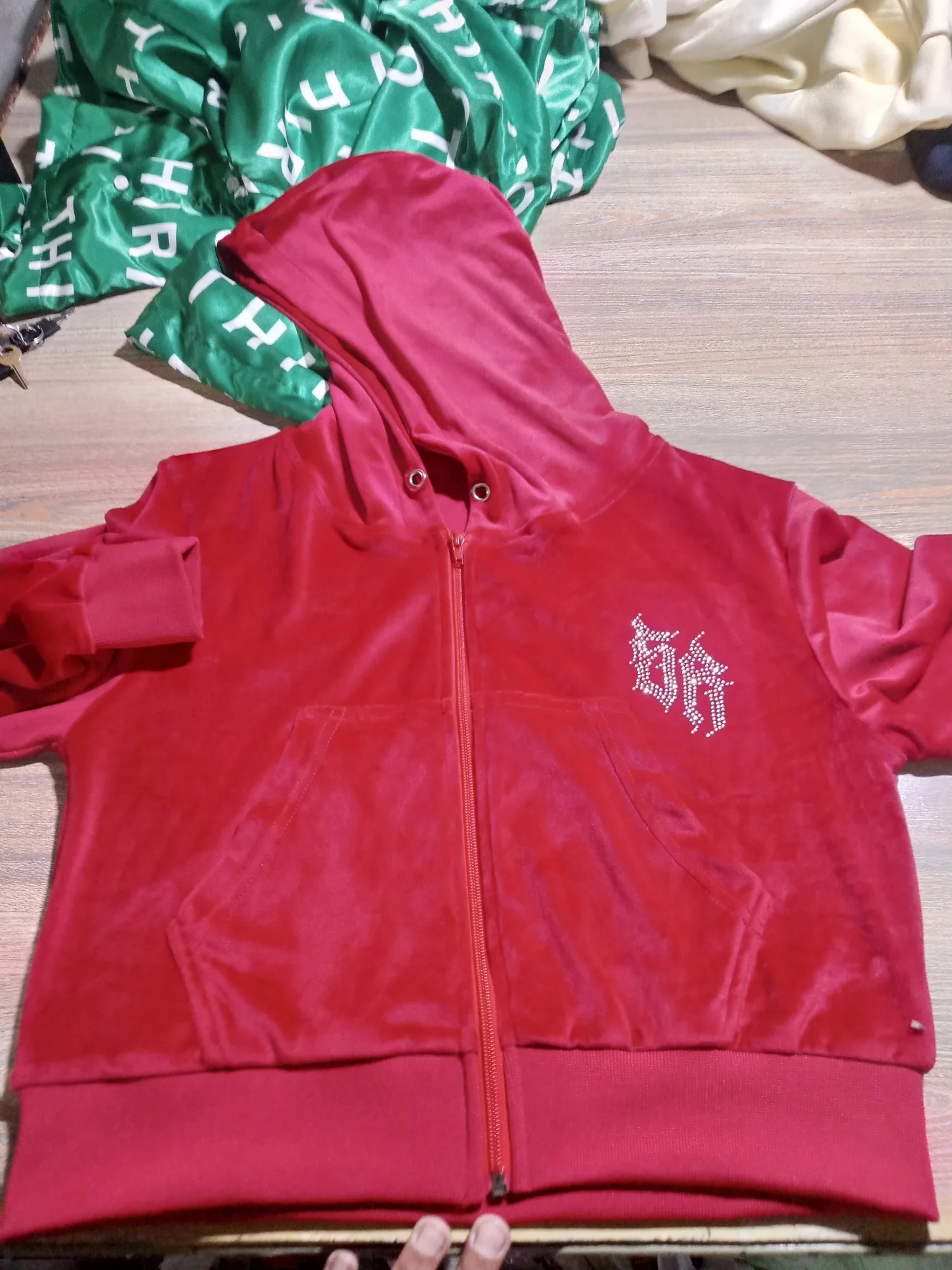 Red velour zip hoodie with rhinestone logo