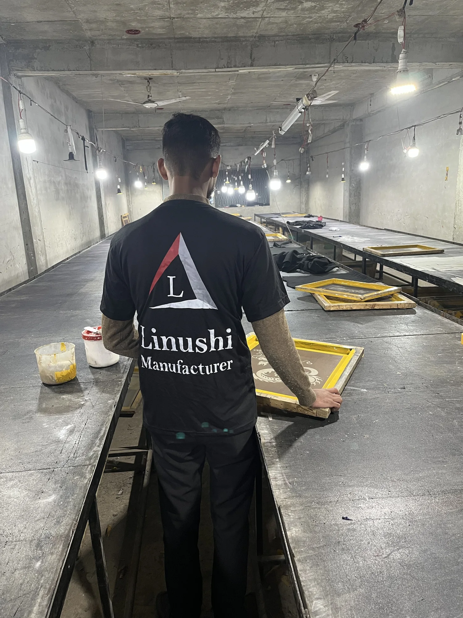 Linushi team member at the screen printing tables