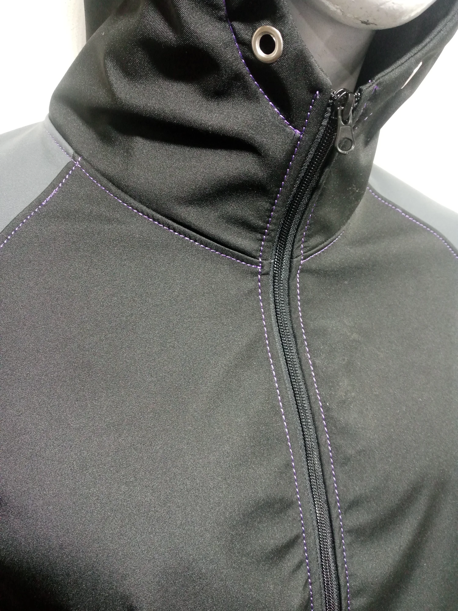 Zip and collar detail with purple contrast stitching