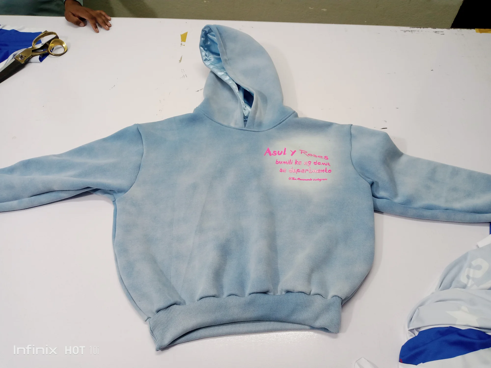 Sun-faded blue hoodie with satin-lined hood and puff print
